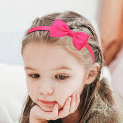 XIMA headband beside coin illustrating size and scale
