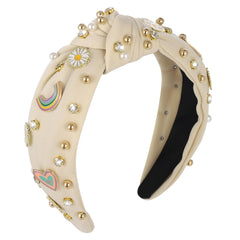 XLSXEXCL headband front view showing beige fabric and daisy accents for versatile styling