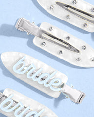 xo, Fetti clips held in hand showing compact size and travel convenience
