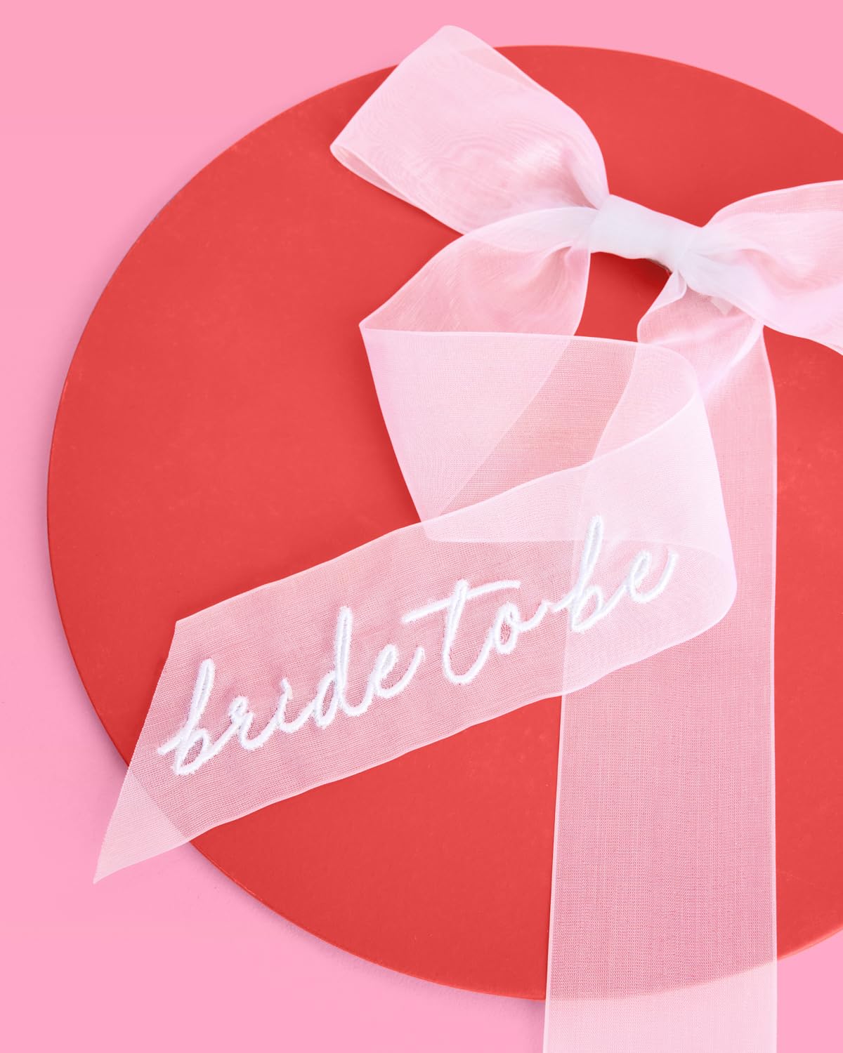 xo, Fetti close-up of embroidered 'Bride To Be' script emphasizing refined detailing