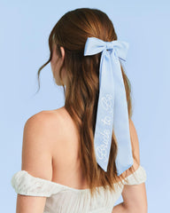 xo, Fetti bow in bridal party setting creating coordinated celebration style