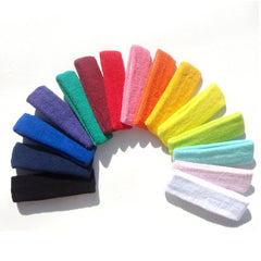 Yeshan headband beside hand for scale, shows 2-inch width coverage