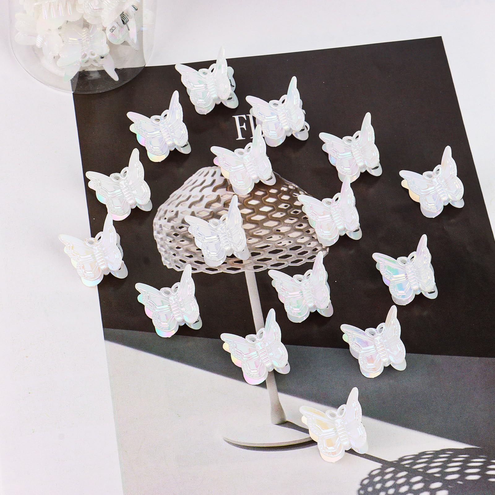 YISSION white butterfly clips scattered on tabletop showing quantity and finish