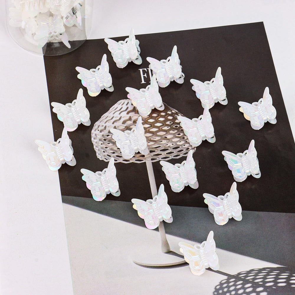 YISSION white butterfly clips scattered on tabletop showing quantity and finish