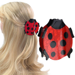 Ynxee ladybug front view showing bright red design and secure clasp benefit