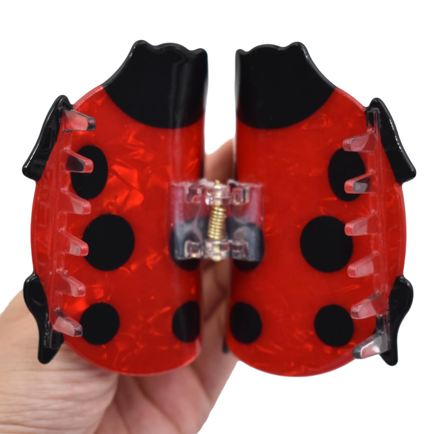 Ynxee ladybug clipped in medium-thick hair illustrating stable all-day hold benefit