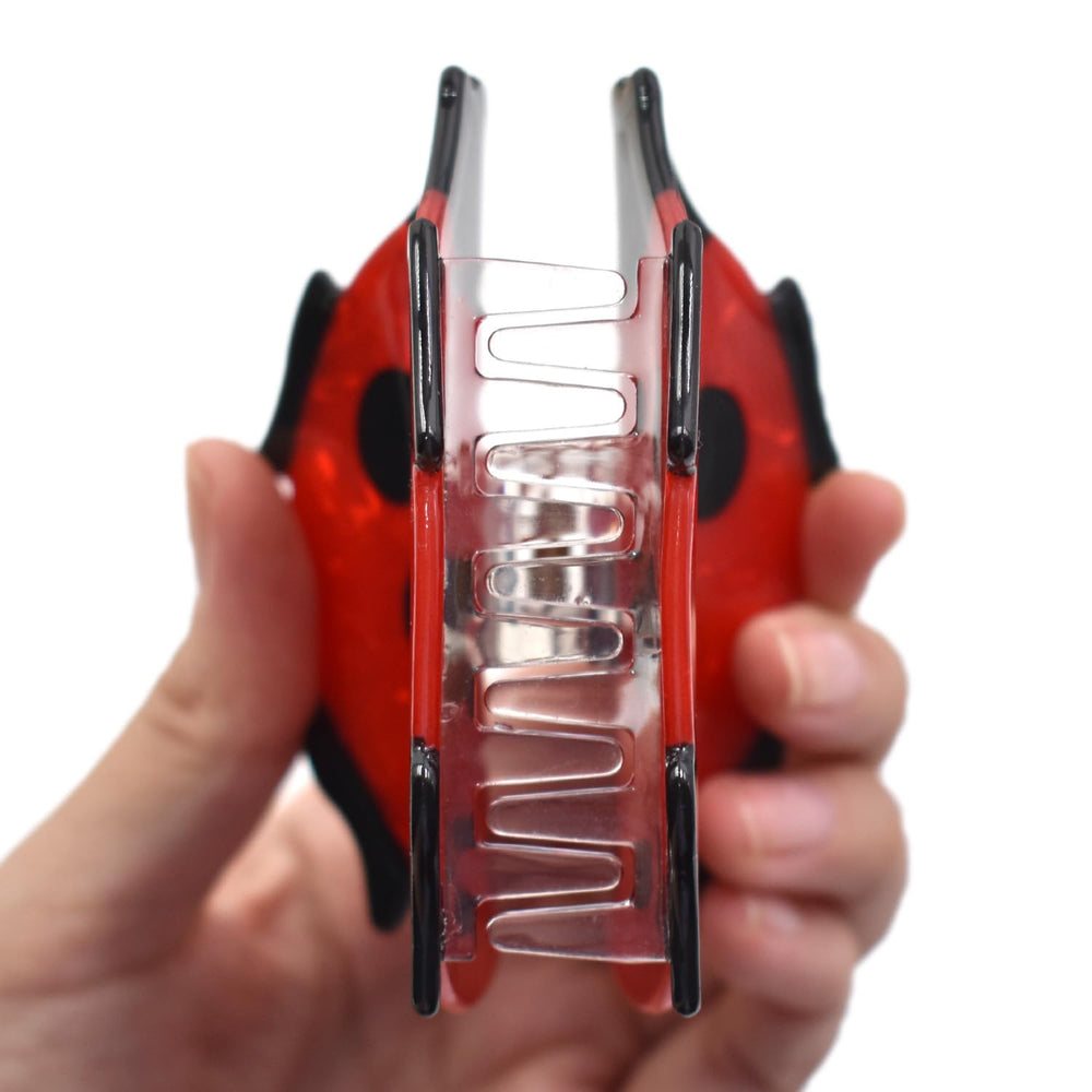 Ynxee ladybug styled on vanity in pouch showing travel-ready convenience benefit