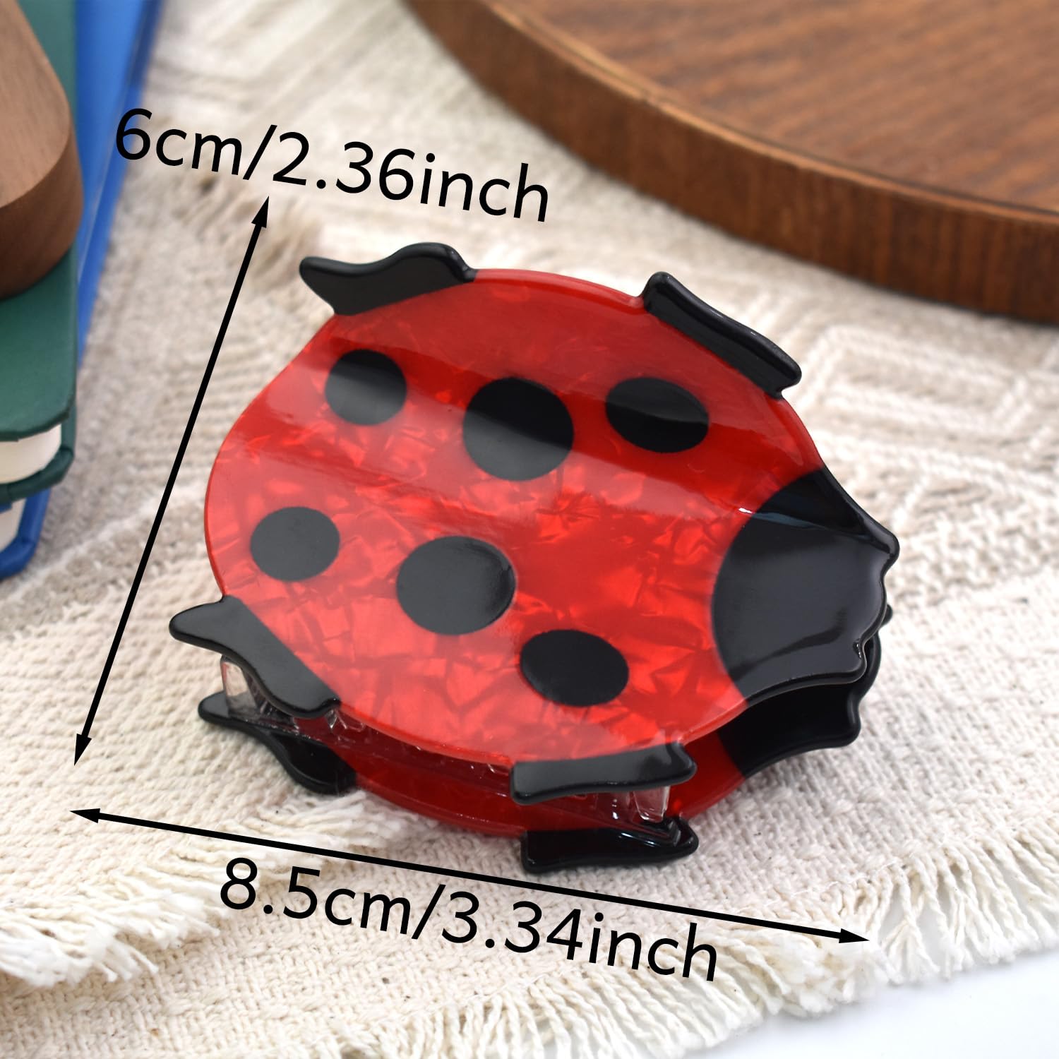 Ynxee ladybug next to ruler showing 3.3 inch size for accurate fit benefit