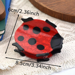 Ynxee ladybug next to ruler showing 3.3 inch size for accurate fit benefit