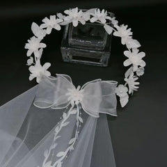 yuruyi flower crown next to hand indicating adjustable size and light weight
