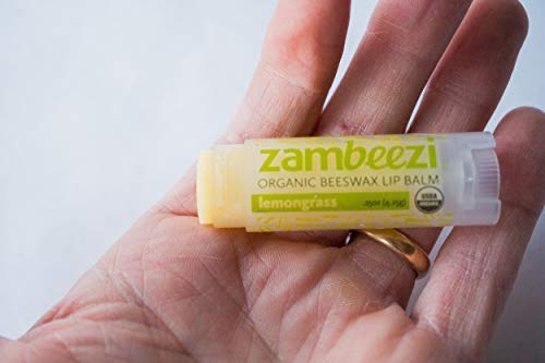 Zambeezi applying balm outdoors showing fresh lemongrass aroma and quick relief benefit