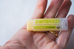 Zambeezi applying balm outdoors showing fresh lemongrass aroma and quick relief benefit