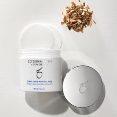 ZO SKIN HEALTH pad being applied to cheek to visibly reduce oil and build-up