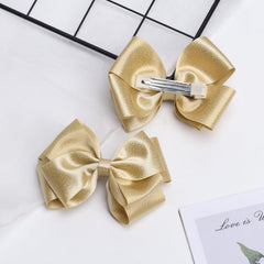 Zolyco bow clipped to baby bangs offering gentle hold and cute accent